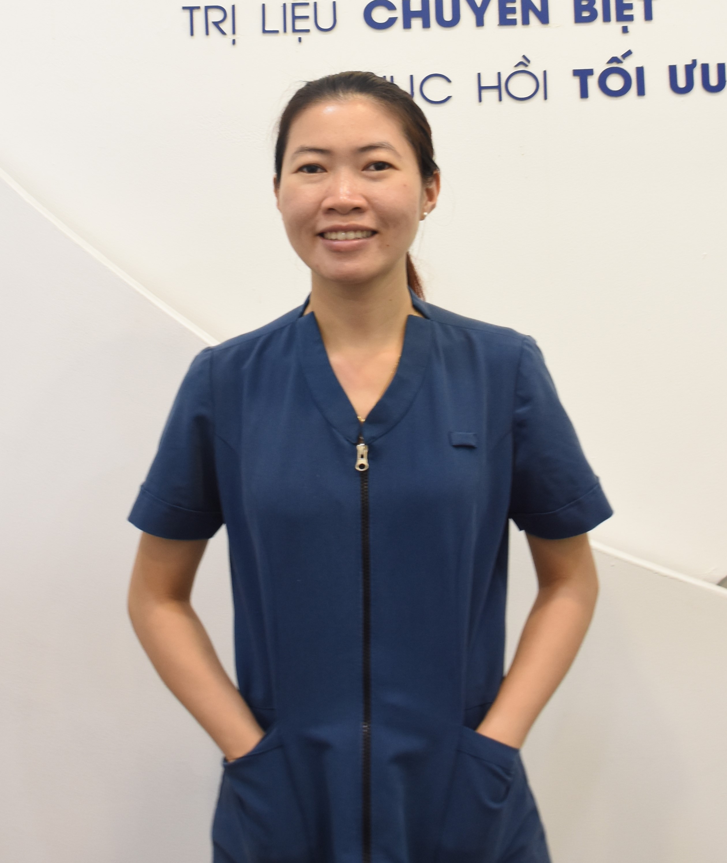 A professional medical doctor wearing a white coat, smiling at the camera.