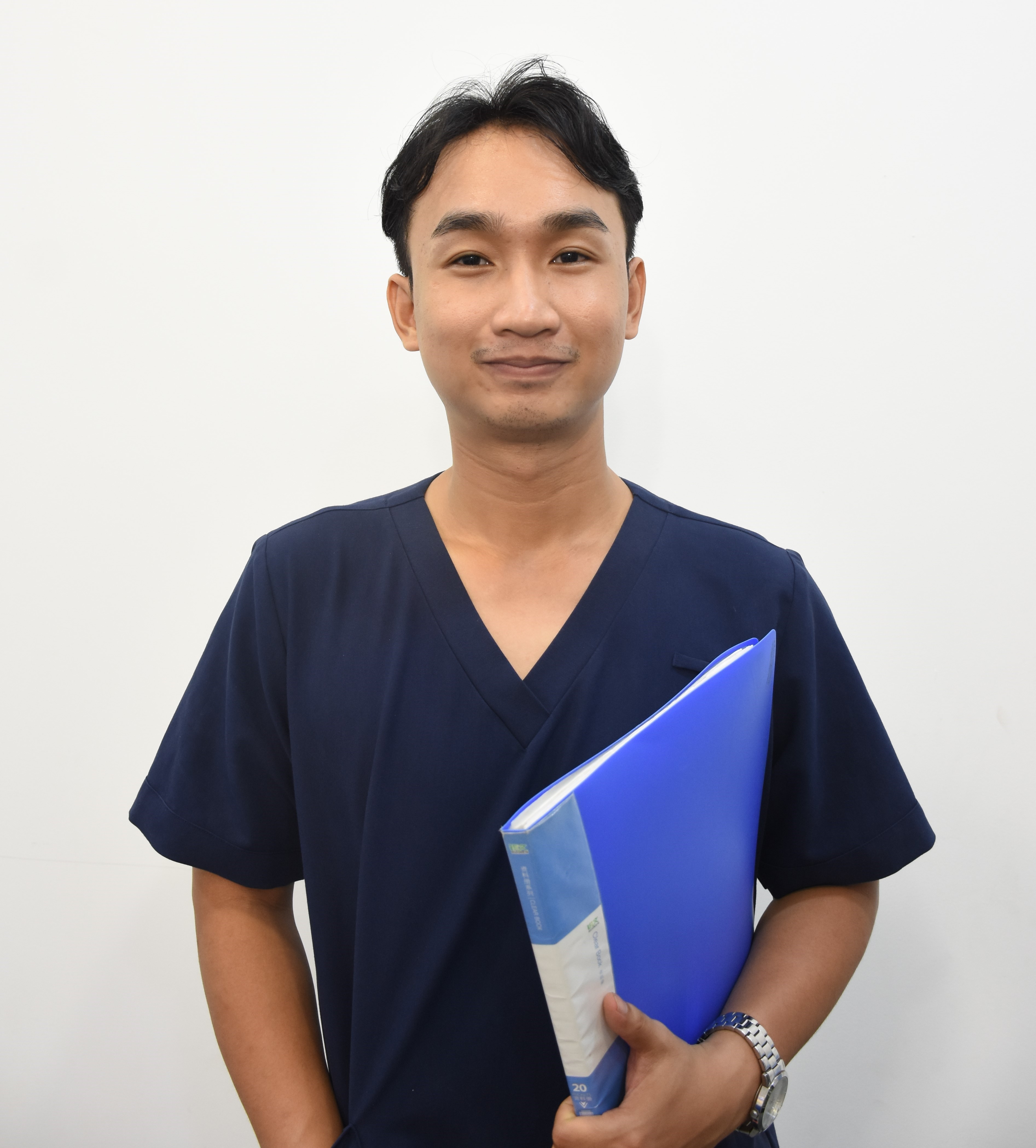 Doctor in a white lab coat, smiling, male